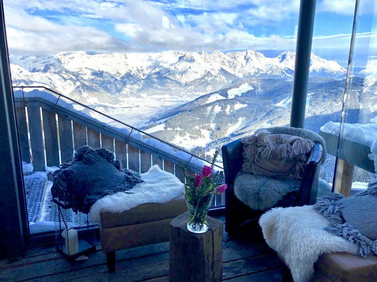 Blick durch Glasscheibe auf Berglandschaft mit Schnee