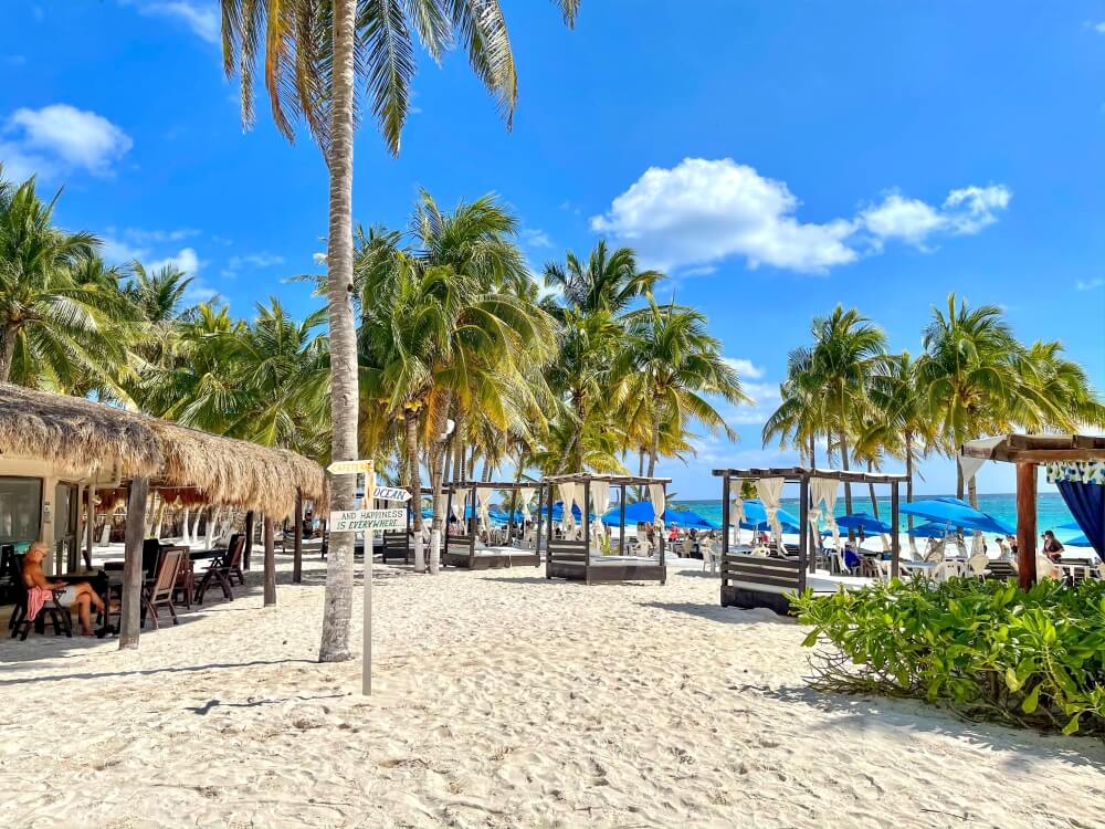 Blick auf Beachclub mit Liegen und Schirmen in Tulum